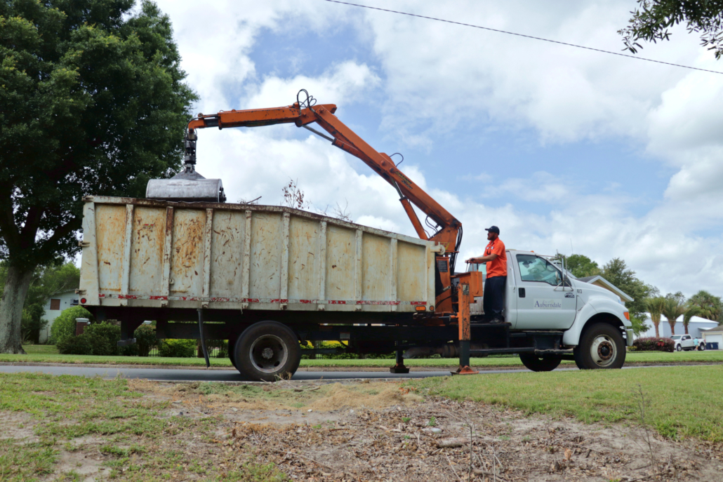 A municipal claw truck, removing debris from street
