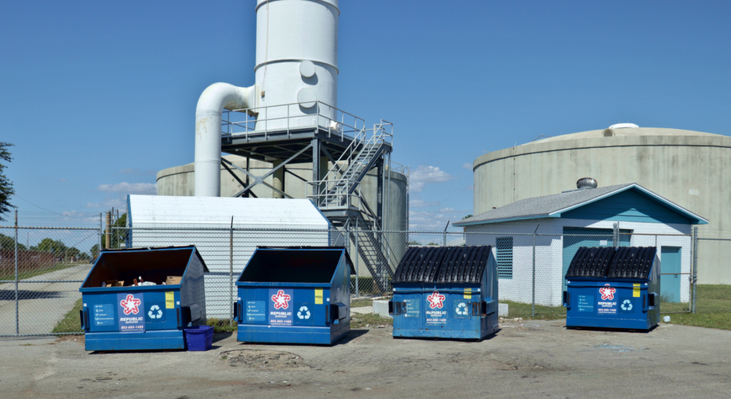 Four dumpsters located at Public Works office recycling area