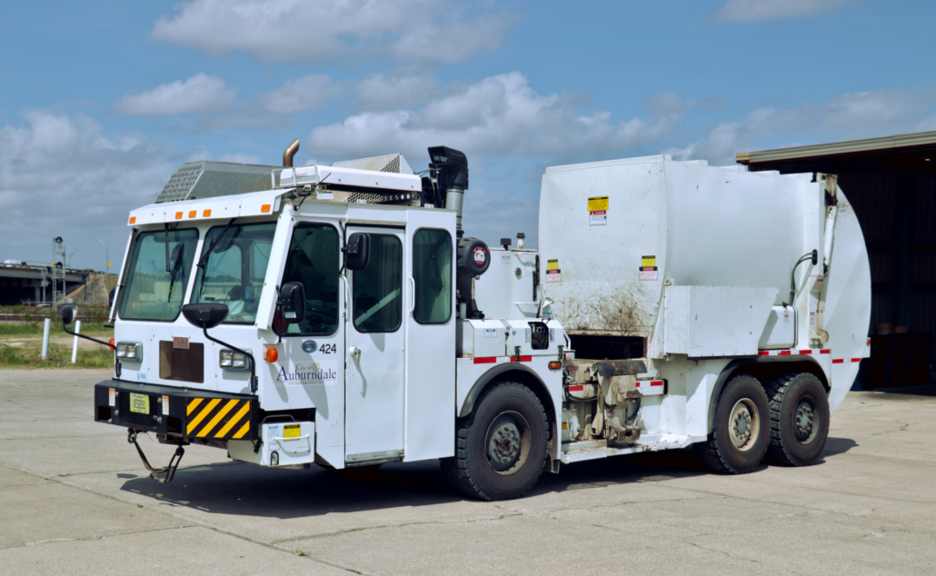 A side-loading sanitation truck